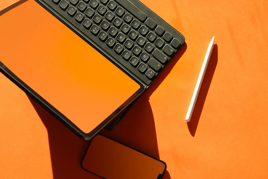 Dual monitors on a desk, showcasing web design in a modern office setting.